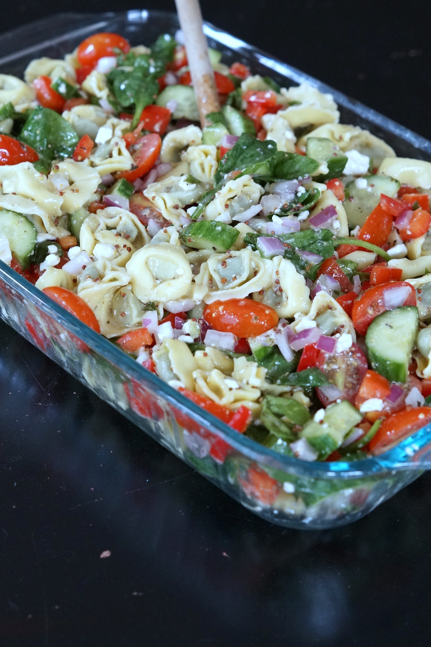 Looking for the perfect dish for a pot luck that doesn't require a lot of time in the kitchen? Bring this crowd-pleasing tortellini pasta salad.